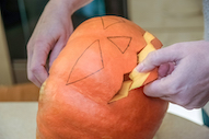 Person carving a pumpkin